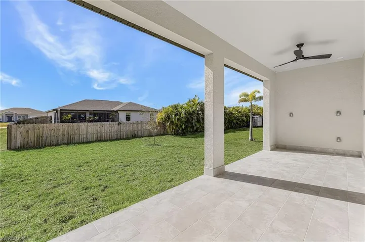 Fenced backyard featuring a patio area and ceiling fan