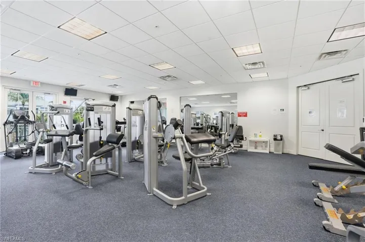 Dedicated fitness center featuring carpeted flooring and recessed lighting