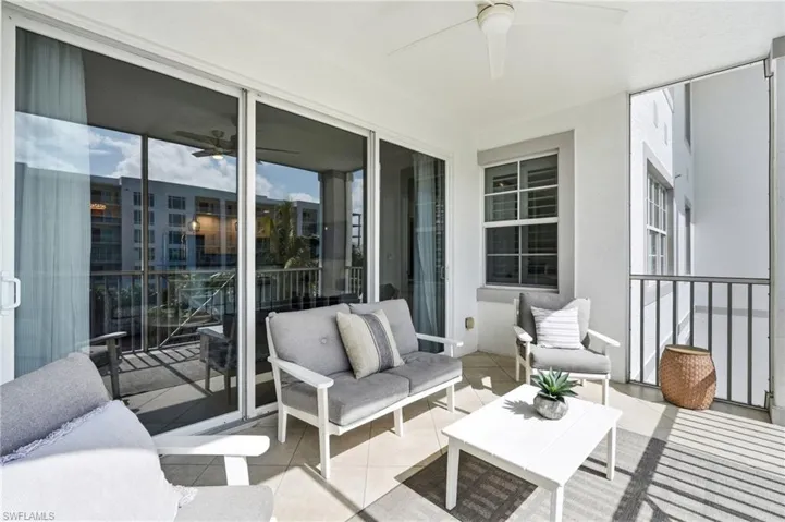 Screened-in balcony featuring tile flooring and a ceiling fan