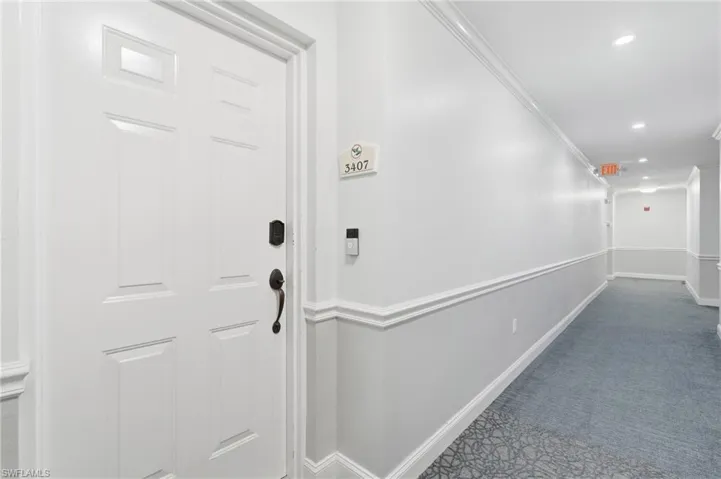 White paneled entry door with dark bronze hardware