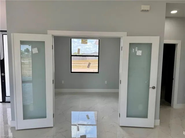 Unfurnished room with light marble finish flooring