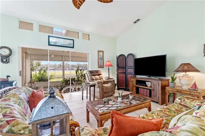 Living room featuring high vaulted ceiling