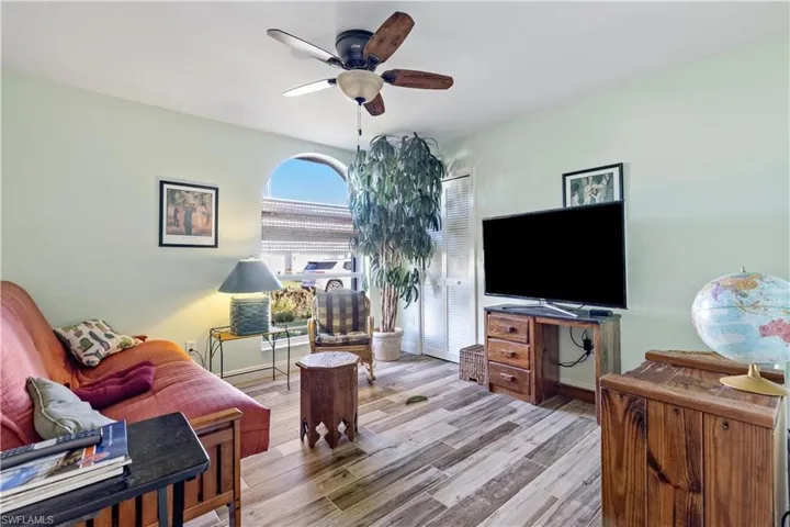 Living room featuring ceiling fan and light hardwood / wood-style flooring