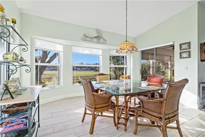 Dining space with lofted ceiling and a wealth of natural light