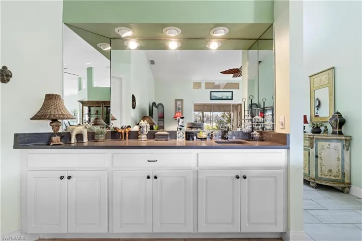 Bar with sink and white cabinetry