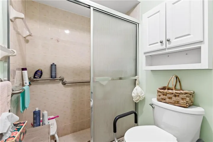 Bathroom with toilet and a shower with door