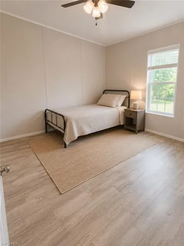 Neutral-toned room featuring light wood-finish flooring