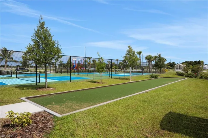 View of community with a tennis court and a bocce ball area