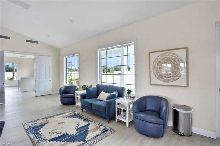 Living area with lofted ceiling and light wood finished floors