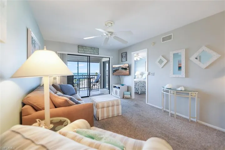 Living area featuring carpet floors and a ceiling fan