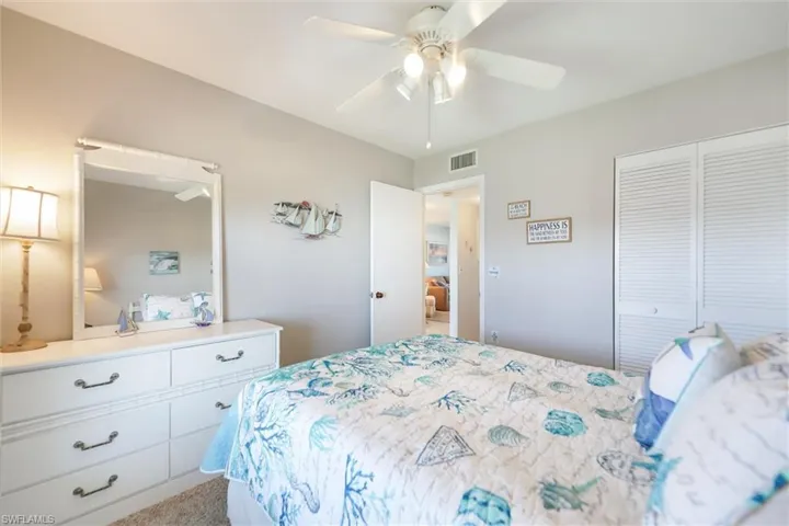Bedroom featuring carpet flooring, a closet, and a ceiling fan