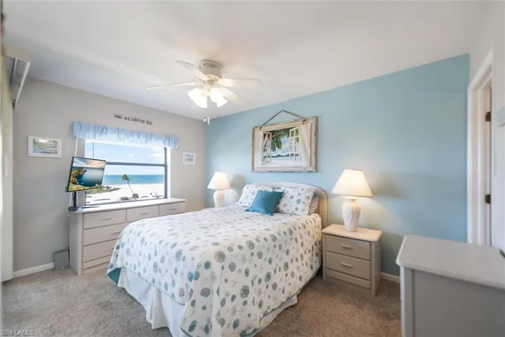 Bedroom featuring a ceiling fan and carpet