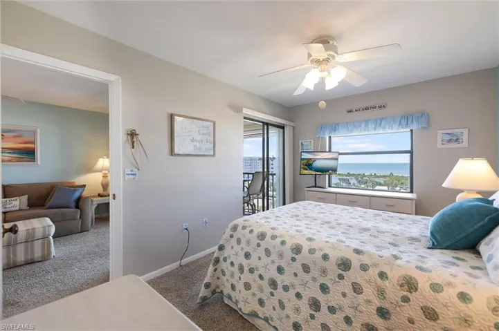 Bedroom with access to exterior, carpet floors, and ceiling fan