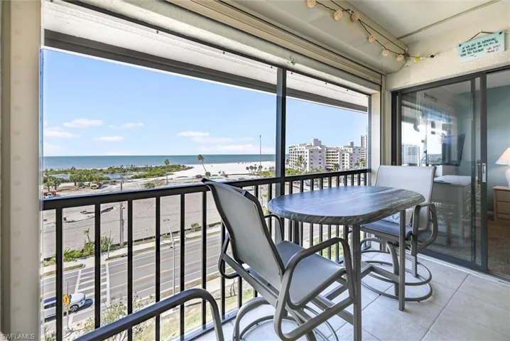 Balcony featuring a water view and outdoor dining space