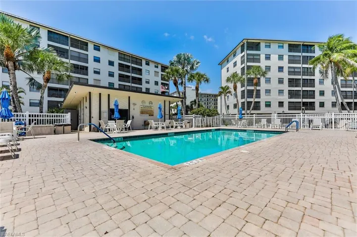 Community pool with a patio