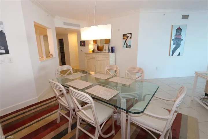 Dining room featuring crown molding, visible vents, and light tile patterned floors