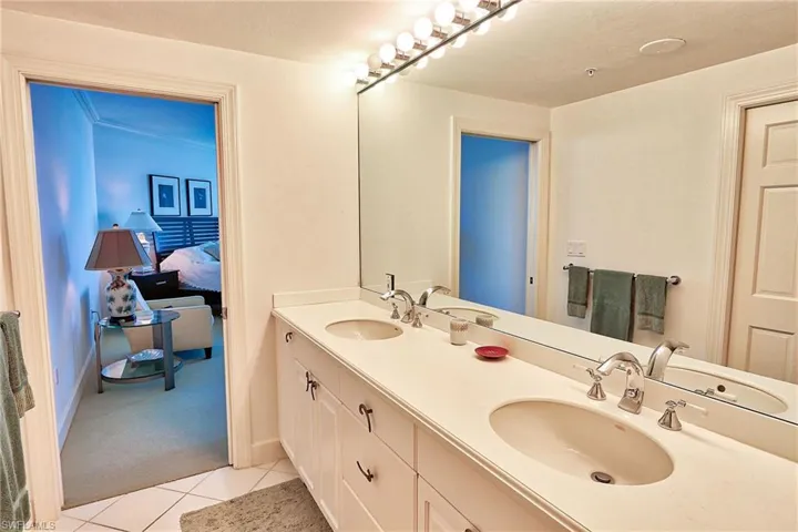 Ensuite bathroom with tile patterned floors, ensuite bathroom, and a sink