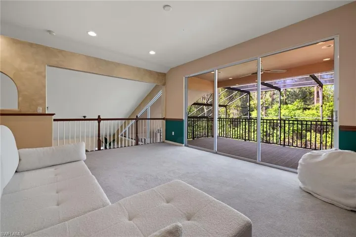 Living room with a sunroom, a ceiling fan, carpet, and recessed lighting