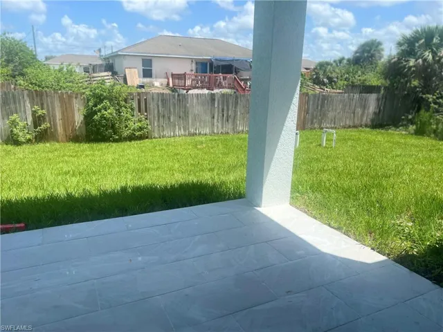 Fenced backyard with a patio