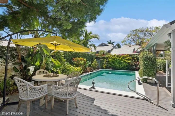 View of pool with a deck and landscaping