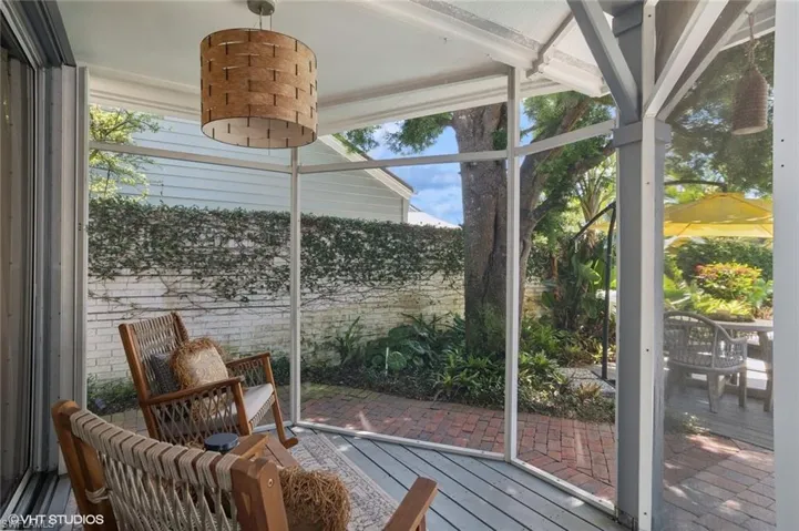 Screened in porch with with pool and landscaping view.