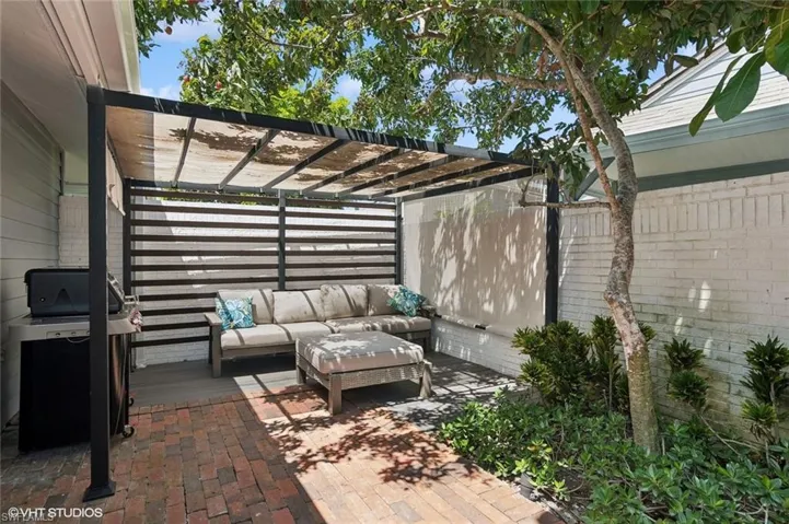 View of terrace featuring outdoor Pergola entertainment area with grill.