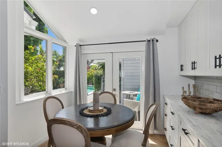 Dining area with plenty of natural light, hardwood / wood-style flooring, and lofted ceiling
