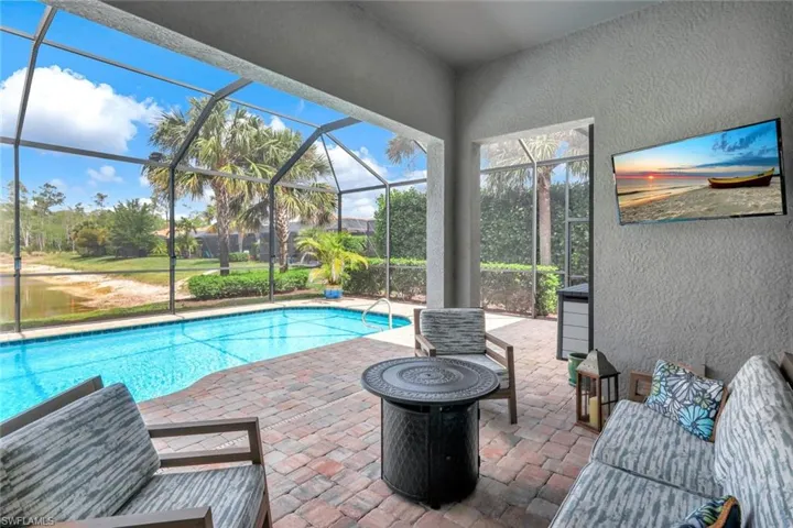 Pool with a lanai and a patio area