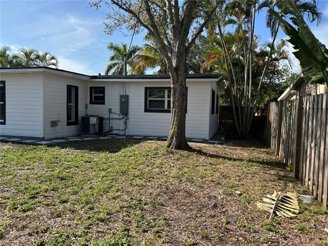 Back of property featuring a fenced backyard and a patio