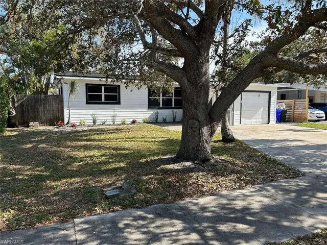 View of front facade with concrete driveway and a garage