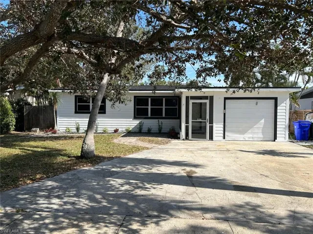 View of front facade with concrete driveway and an attached garage