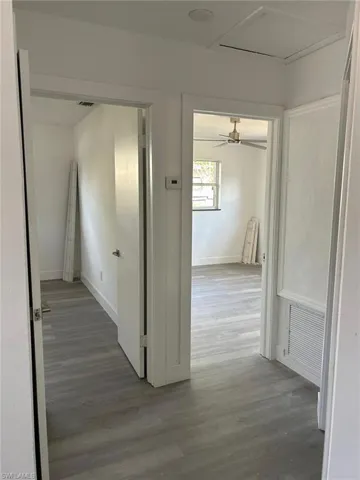 Hall with wood finished floors and attic access