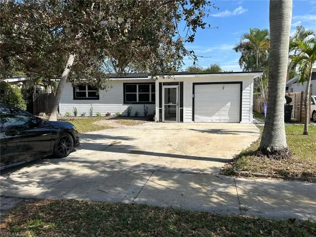 View of front facade with concrete driveway and a garage
