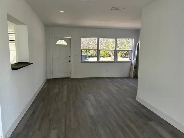 Entryway featuring dark wood-style flooring and recessed lighting