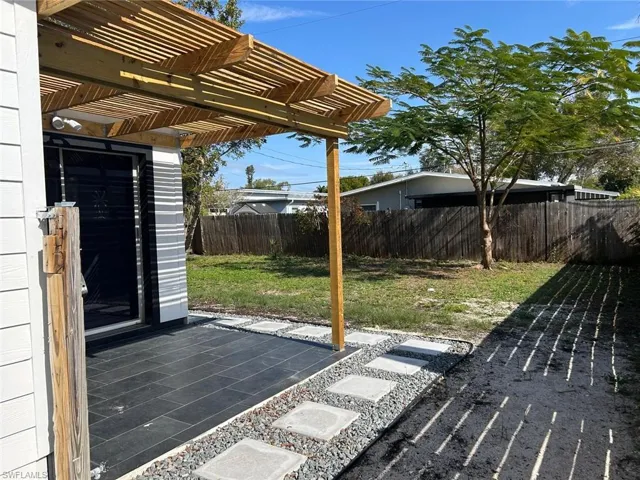 Fenced backyard with a patio area and a pergola