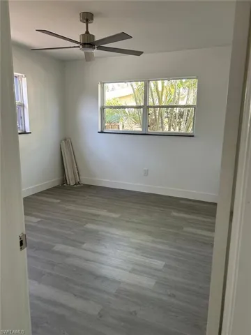 Empty room featuring wood finished floors and a ceiling fan