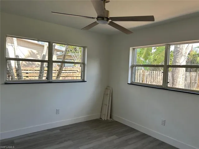 Unfurnished room with wood finished floors and ceiling fan