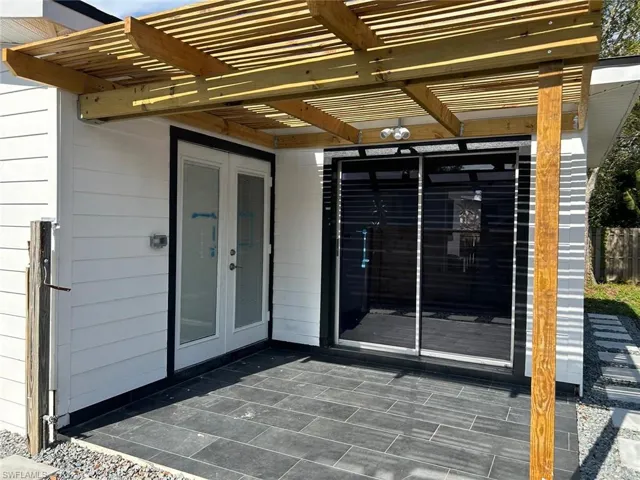 Property entrance with a patio, french doors, and a pergola