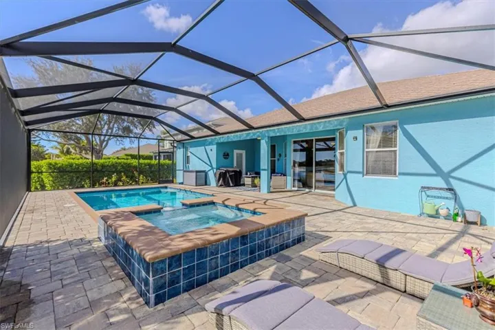 View of swimming pool with a patio, a lanai, a sunroom, and a pool with connected hot tub