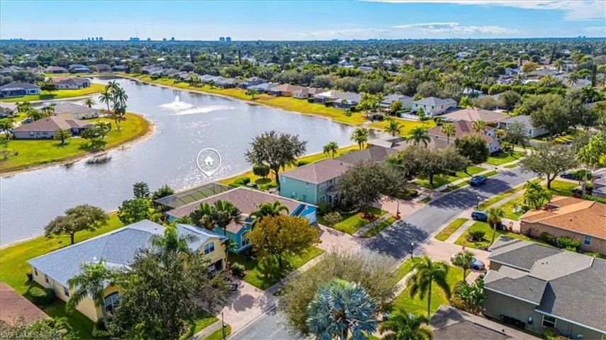 Aerial perspective of suburban area featuring a large body of water