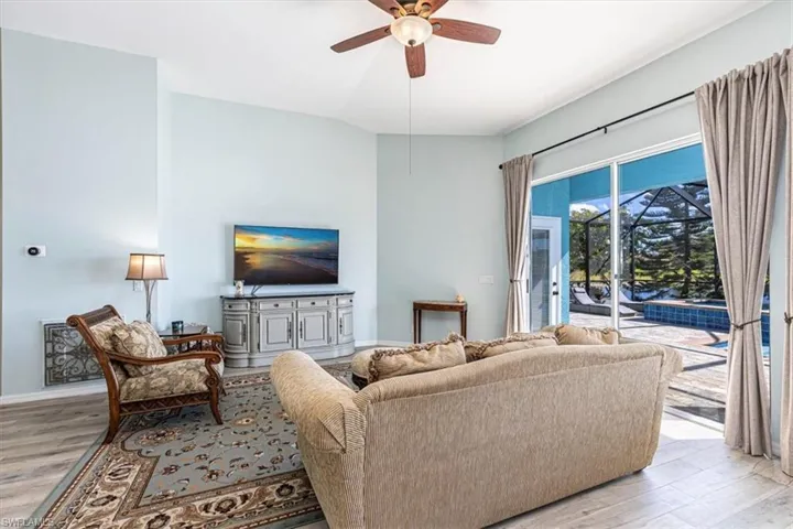 Living room featuring light wood-type flooring and ceiling fan