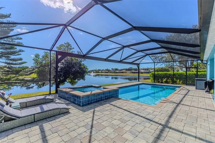 View of swimming pool with a sunroom, glass enclosure, and a patio