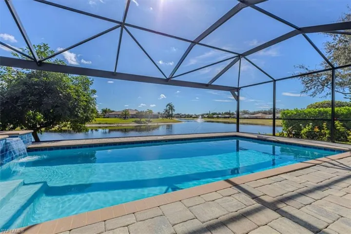 Outdoor pool featuring a water view, a lanai, and a sunroom