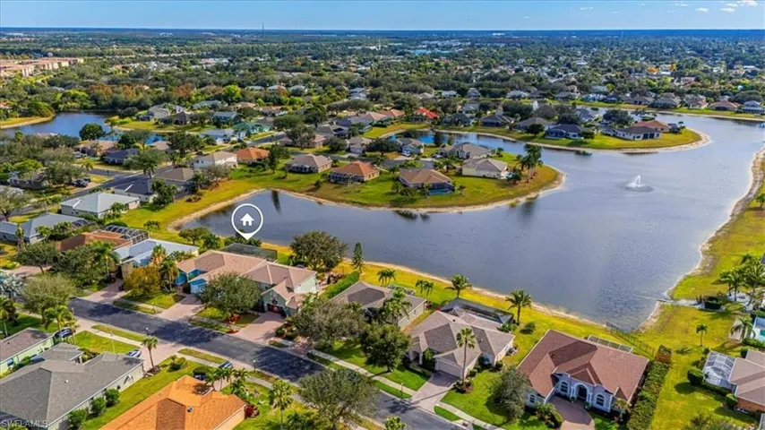 Aerial perspective of suburban area featuring a nearby body of water