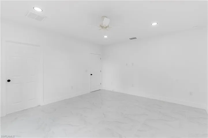 Unfurnished room featuring recessed lighting, light marble finish flooring, and ceiling fan