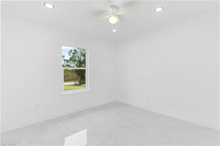 Unfurnished room with light marble finish flooring, ceiling fan, and recessed lighting