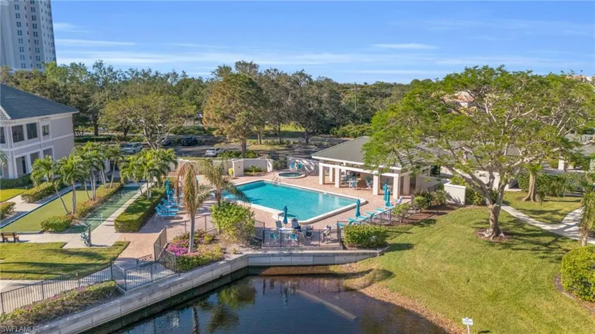 View of swimming pool with a water view and a patio