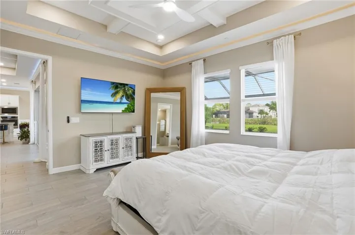 Bedroom with light wood-style flooring, ceiling fan, beamed ceiling, crown molding, and recessed lighting