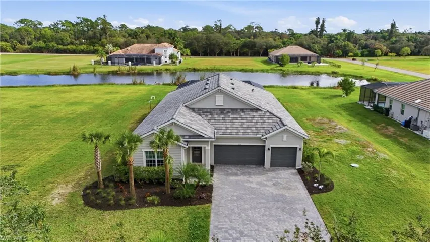 Drone / aerial view of a large body of water and a tree filled landscape