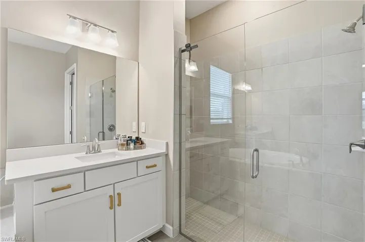 Bathroom with vanity and a stall shower